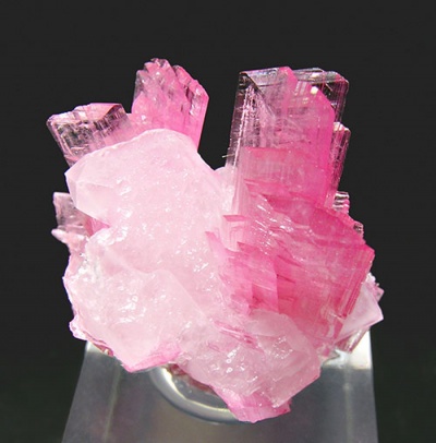 What gemstone with a pink or rose-red crystals can rival the deep color of rubies?